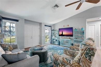Living room featuring ceiling fan, lofted ceiling,