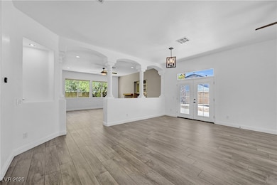 Unfurnished living room featuring ceiling fan, dec