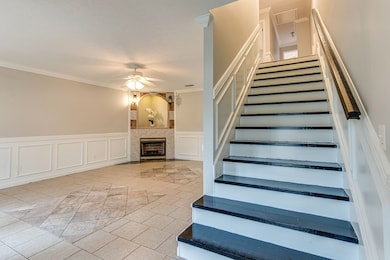 As you enter the front door, you are greeted with hardwood steps and a large living room with a fireplace (no gas logs installed).  All tile floors, freshly painted and wainscoting throughout the room.