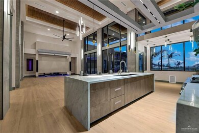 Kitchen featuring pendant lighting, a center island with sink, light hardwood / wood-style floors, and ceiling fan