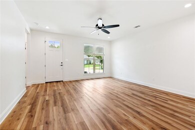 Front door opens to living area & open floor plan.