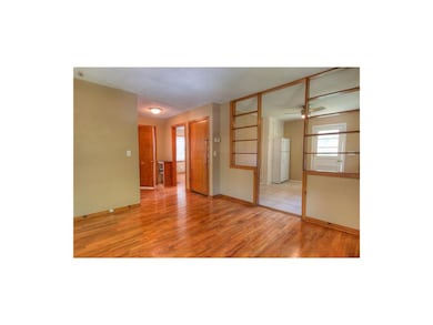 Living room looking into kitchen and master bedroo
