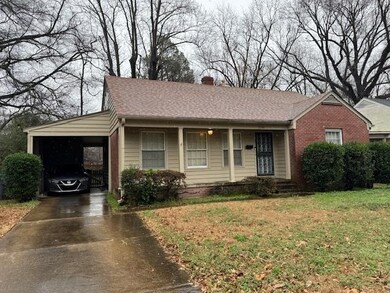 Ranch-style home with a carport and a front yard