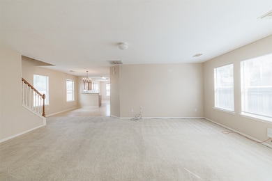 Bright, open living area with multiple windows allowing abundant natural light.