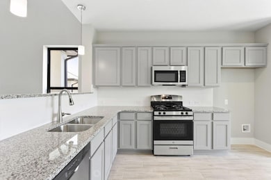 Kitchen featuring stainless steel appliances, gra