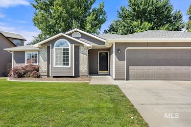 Single story home with a garage, a front yard, and concrete driveway