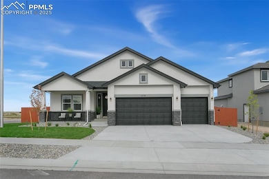 View of front of house with stone siding, stucco siding, a porch, and driveway