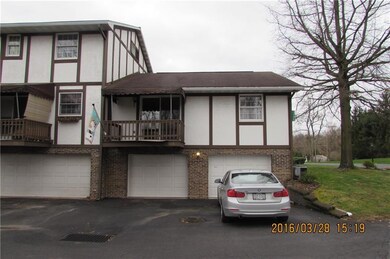 View of rear deck and two car garage.