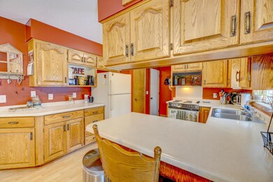 Island with stools and upper cabinets and a pantry