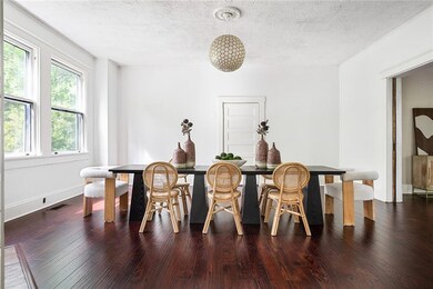 Dining area with a textured ceiling, dark wood-style flooring, and breakfast area