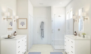 Primary bath with dual sinks and glass shower enclosure