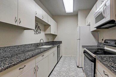 A view of the kitchen with granite counter tops. N