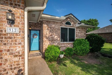 Entrance to property featuring brick siding and a yard