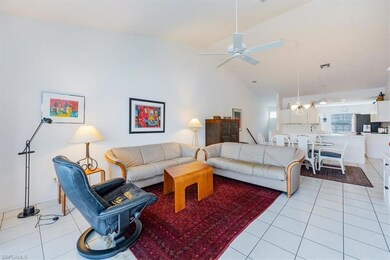 Living room featuring ceiling fan with notable cha