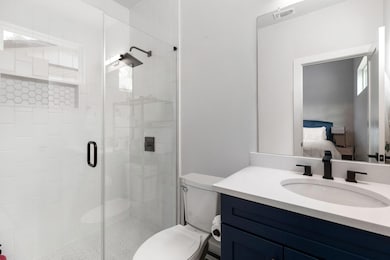 Full bath featuring toilet, vanity, connected bat