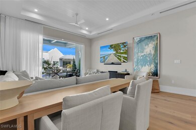 Dining space with a raised ceiling, light wood-typ