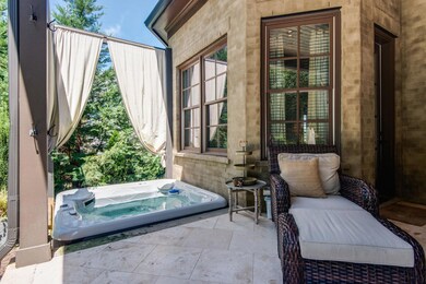 With privacy draperies, find your brand new jetted hot tub just outside the Master Retreat. Relax here after a long day by the pool.