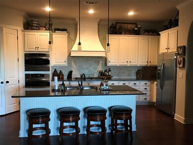 Bright white cook's kitchen with custom vent hood,