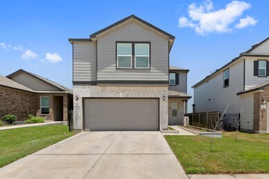 View of front of property with a garage, brick si