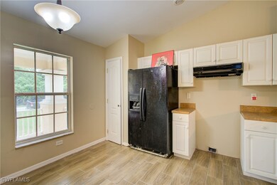 Kitchen featuring black refrigerator with ice disp