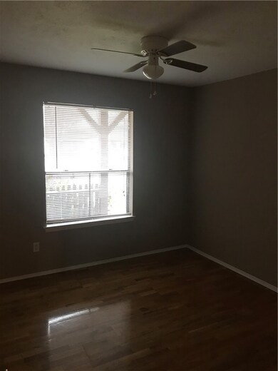 Unfurnished room with dark hardwood / wood-style floors and ceiling fan