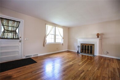 Gleaming hardwood floors & a wood burning fireplac
