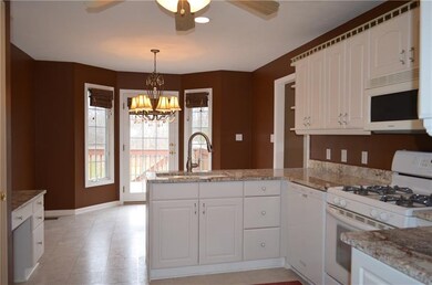 Kitchen has convenient desk and peninsula
