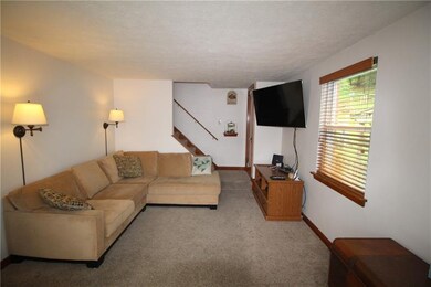 Living room with neutral carpeting.