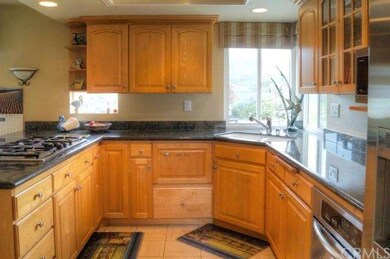 Kitchen; granite surfaces and stainless appliances