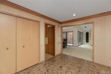 Hall with crown molding, recessed lighting, light colored carpet, and wallpapered walls
