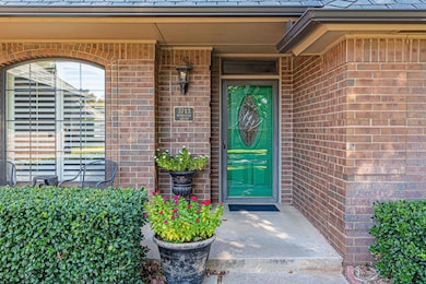 Property entrance featuring brick siding and a porch