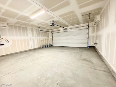 Garage featuring a garage door opener and a wall u