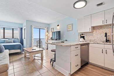 Kitchen featuring light stone countertops, sink, t