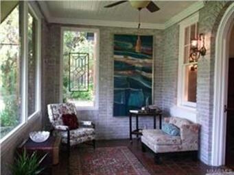 This wonderful sunroom/foyer is a welcoming all-we