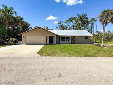 Ranch-style home featuring concrete driveway, an a