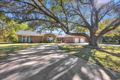 Ranch-style house with a front yard and a garage