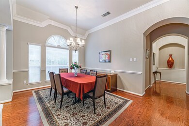The dinning room has plenty of room for an oversized table and features a wall of windows and chair rail.