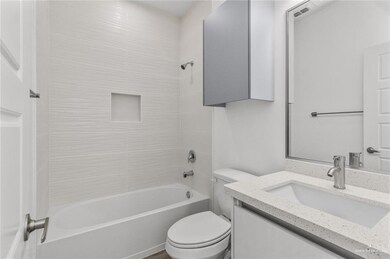 Bathroom with shower / tub combination, toilet, and vanity