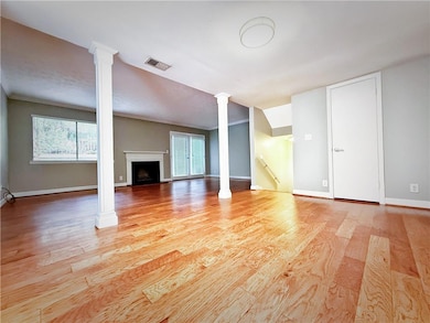 Unfurnished living room with decorative columns, v