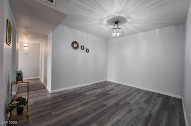 Unfurnished room with dark wood finished floors, a
