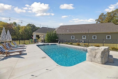 View of pool featuring a patio area and a pergola