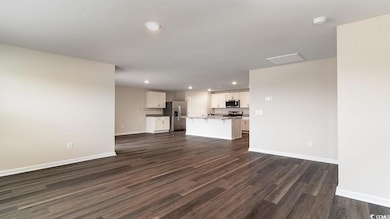 Unfurnished living room featuring dark hardwood / 