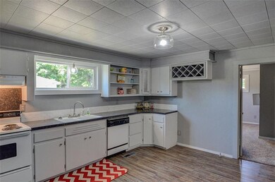 Kitchen view with entrance to master bedroom shown
