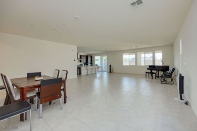 Dining space with light tile patterned floors