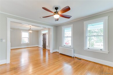 This large living room offers a view of the large front porch and front yard, as well as the extra wide entryway for greeting guests.
