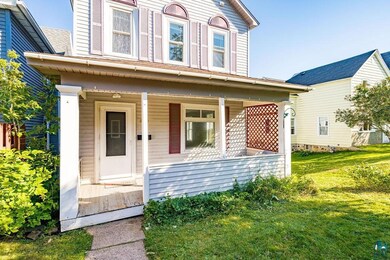 View of front facade with a front yard and a porch