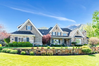 View of front of home with stone siding, a front yard, a mountain view, and a chimney