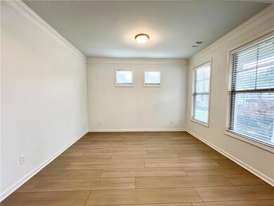 Spare room featuring ornamental molding and light wood-type flooring