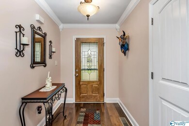Featuring crown molding and wood flooring.