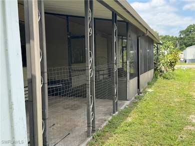 View of side of home featuring a sunroom